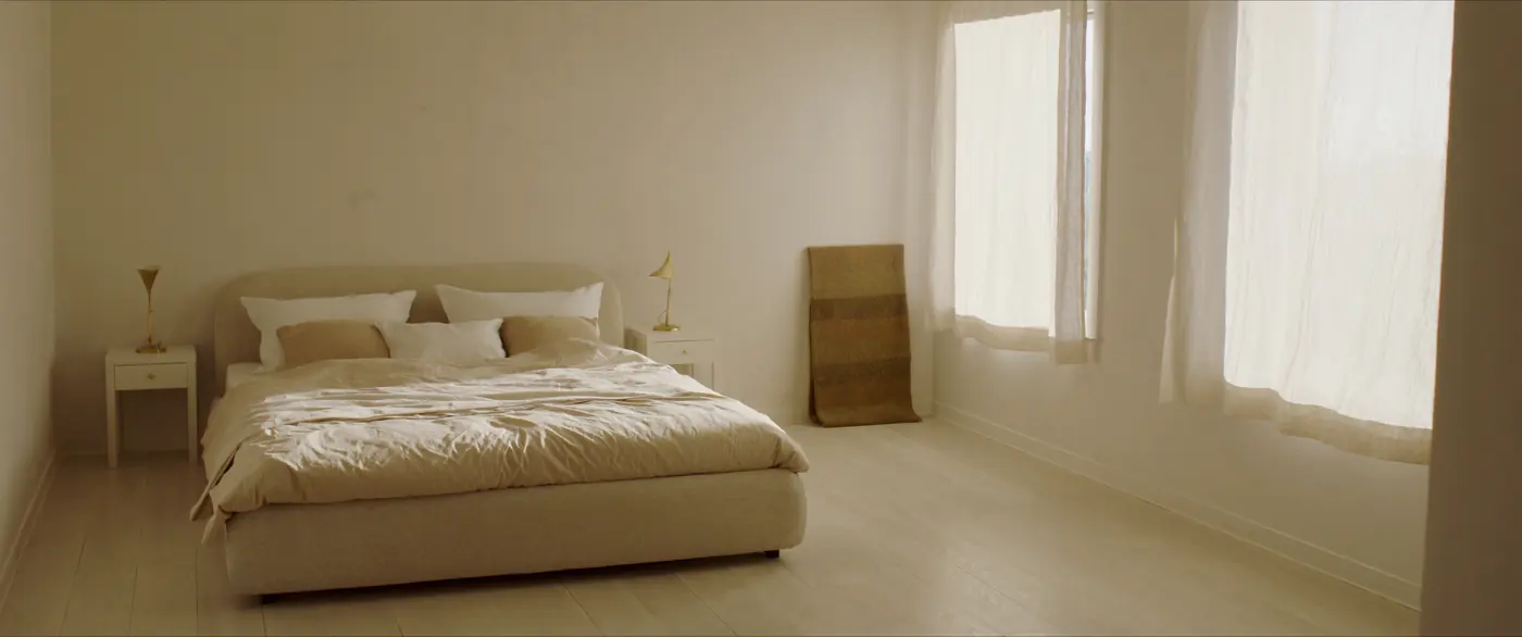 Linen bedroom, low platform bed, morning light